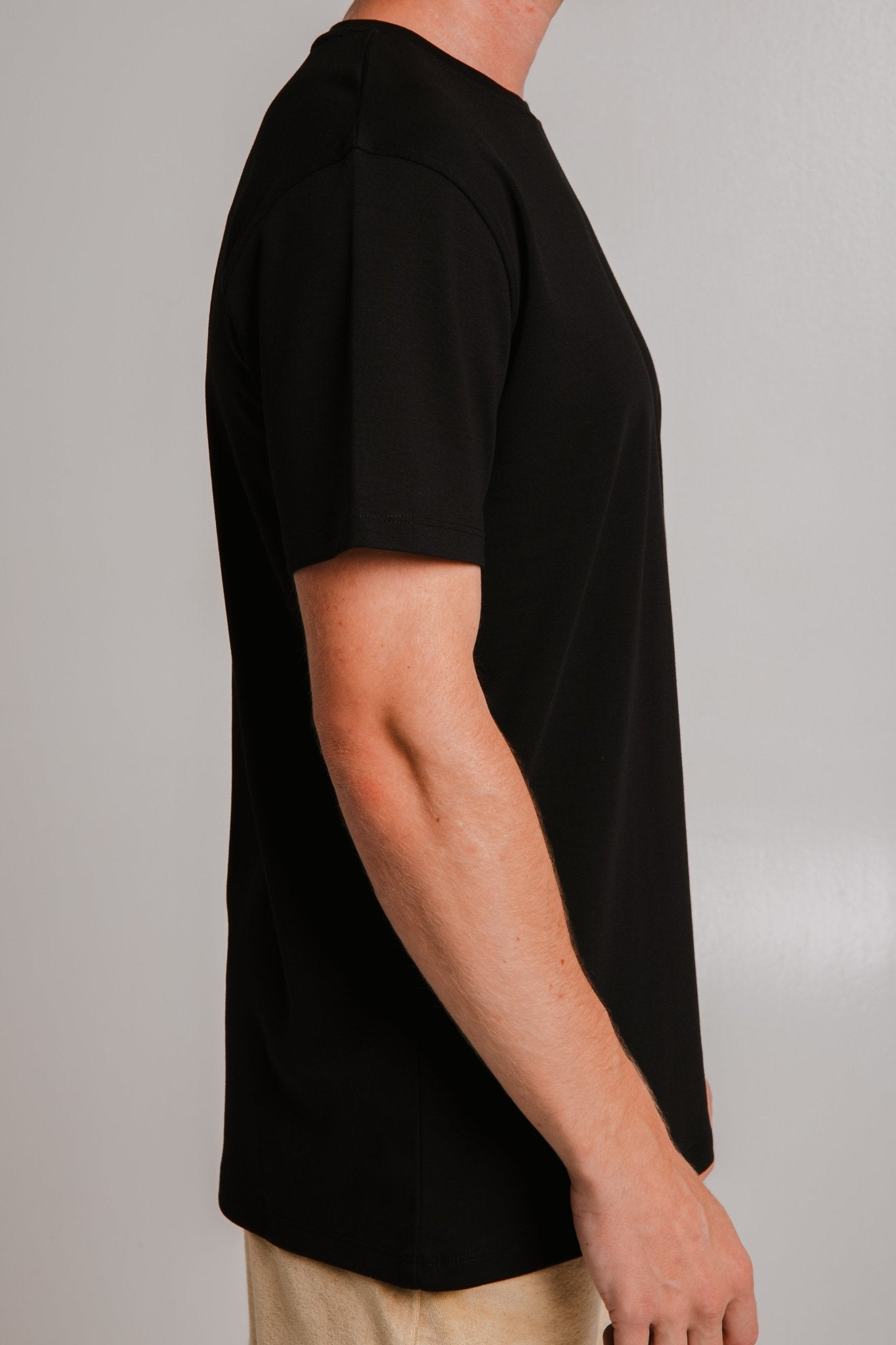 Sossu comfortable heavy weight t-shirt black side view on male model with beige pants