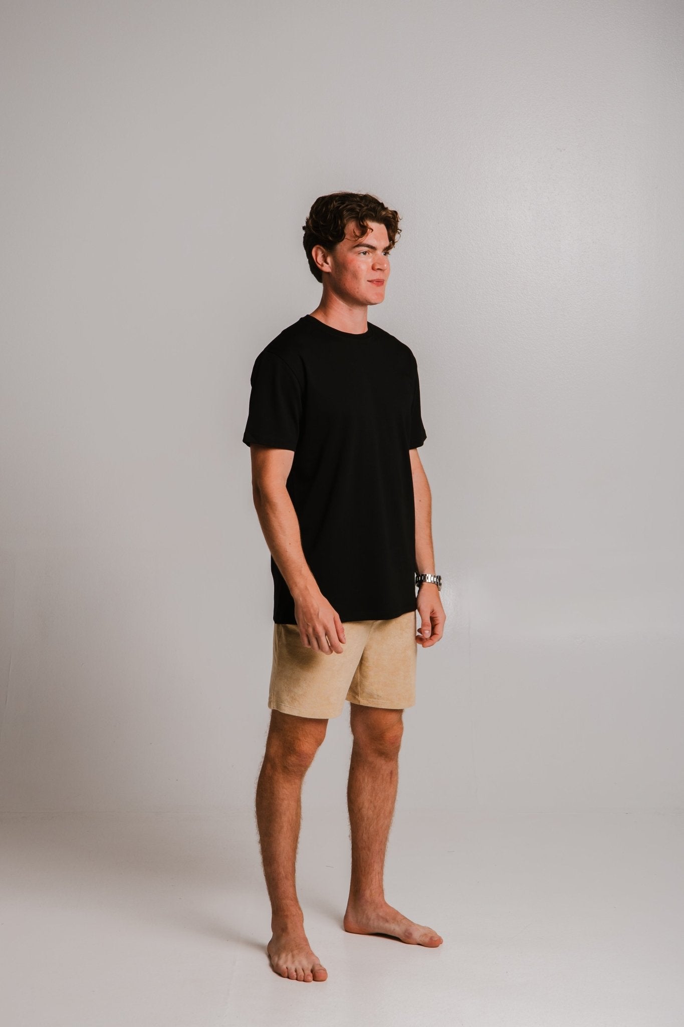 Sossu comfortable heavy weight t-shirt black worn by a male model paired with beige shorts