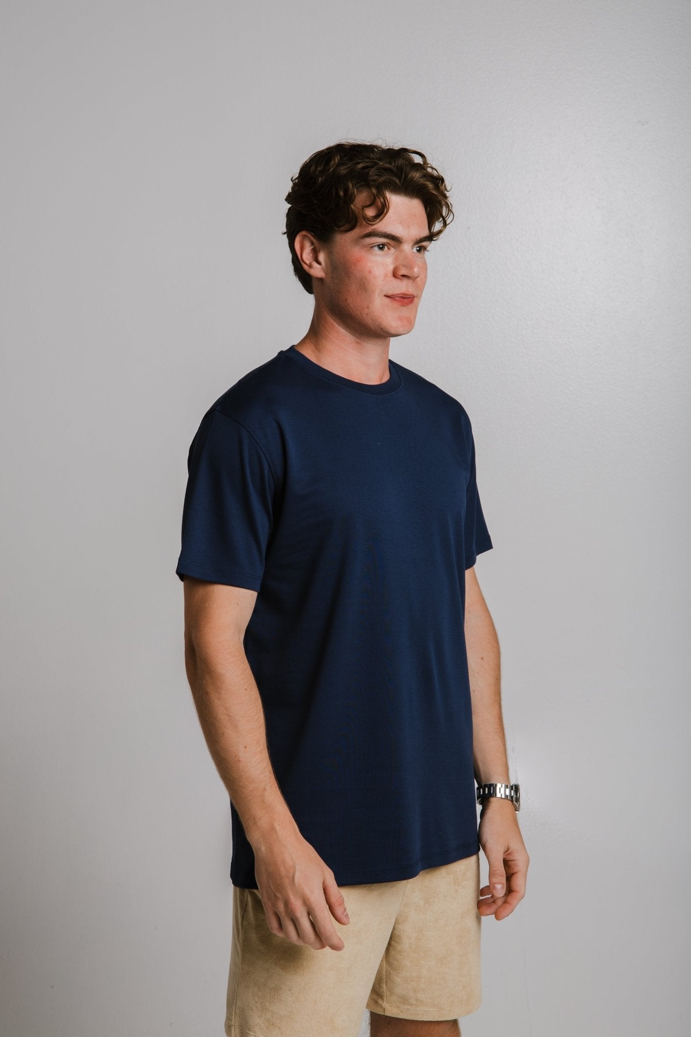 Sossu heavy tshirt dark blue worn by male model with beige shorts and wristwatch
