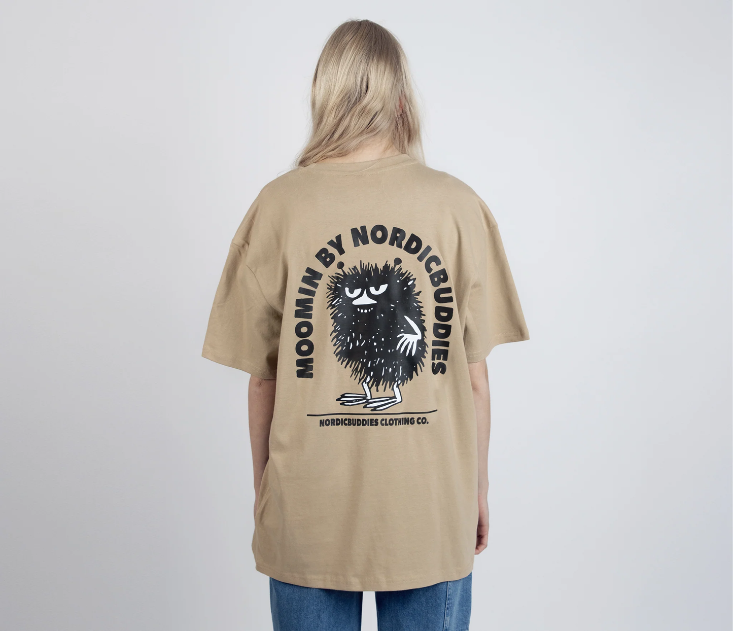 Back view of Stinky Plotting T-Shirt Beige by Moomin NordicBuddies worn by model with graphic print