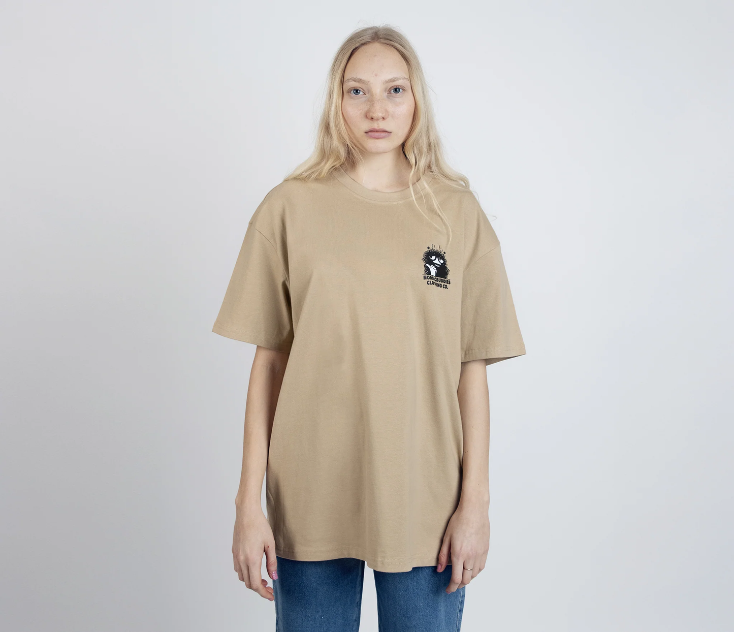 Stinky Plotting T-Shirt Beige by Moomin featuring small graphic on front worn by model with long blonde hair