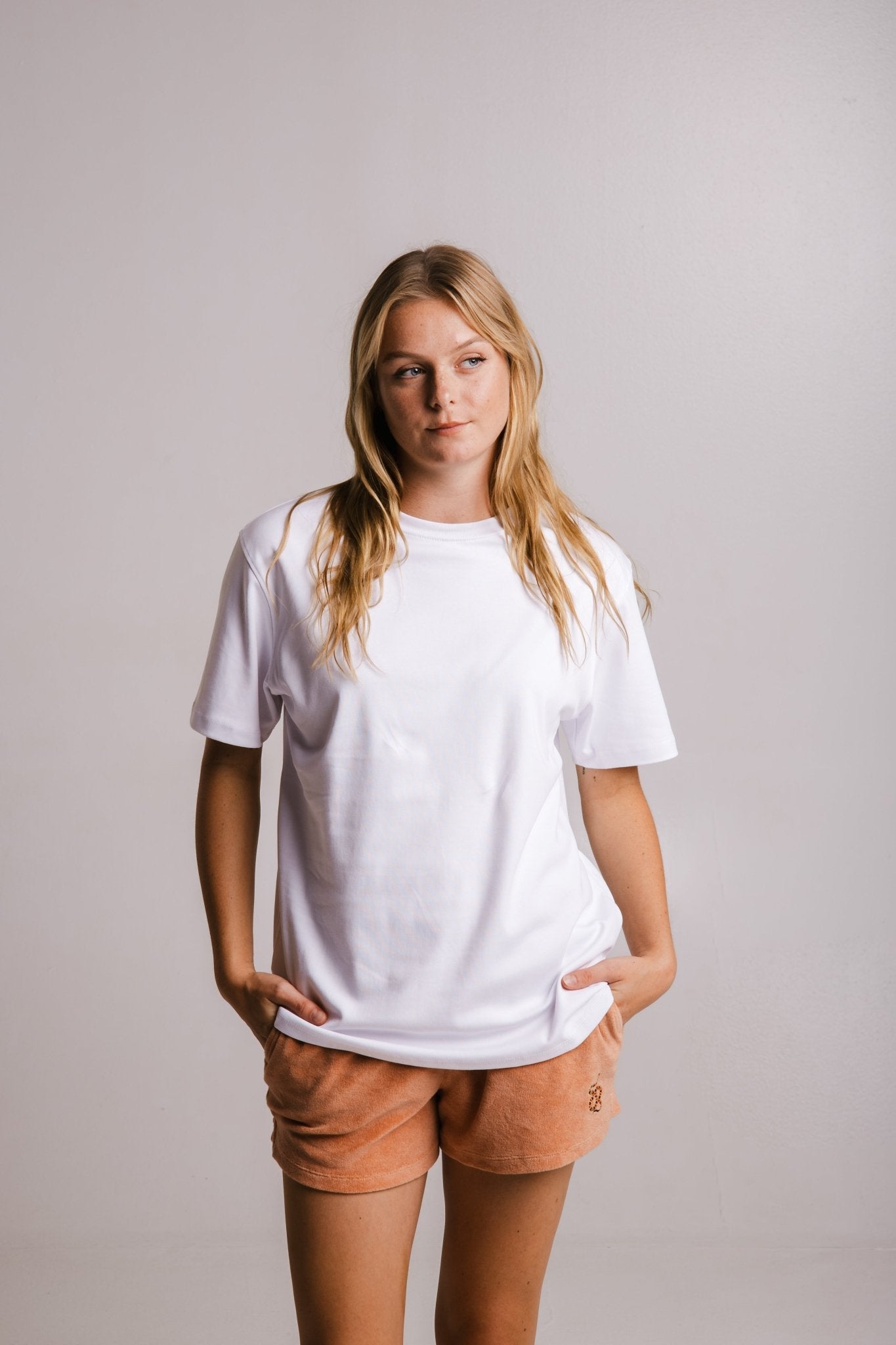 Sossu heavy fabric regular fit unisex t-shirt in white worn by model with hands in pockets
