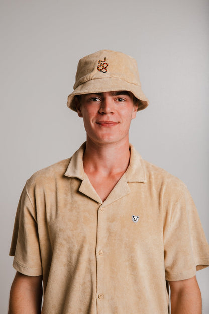 Light brown panda t-shirt by Sossu worn by a young man with matching bucket hat