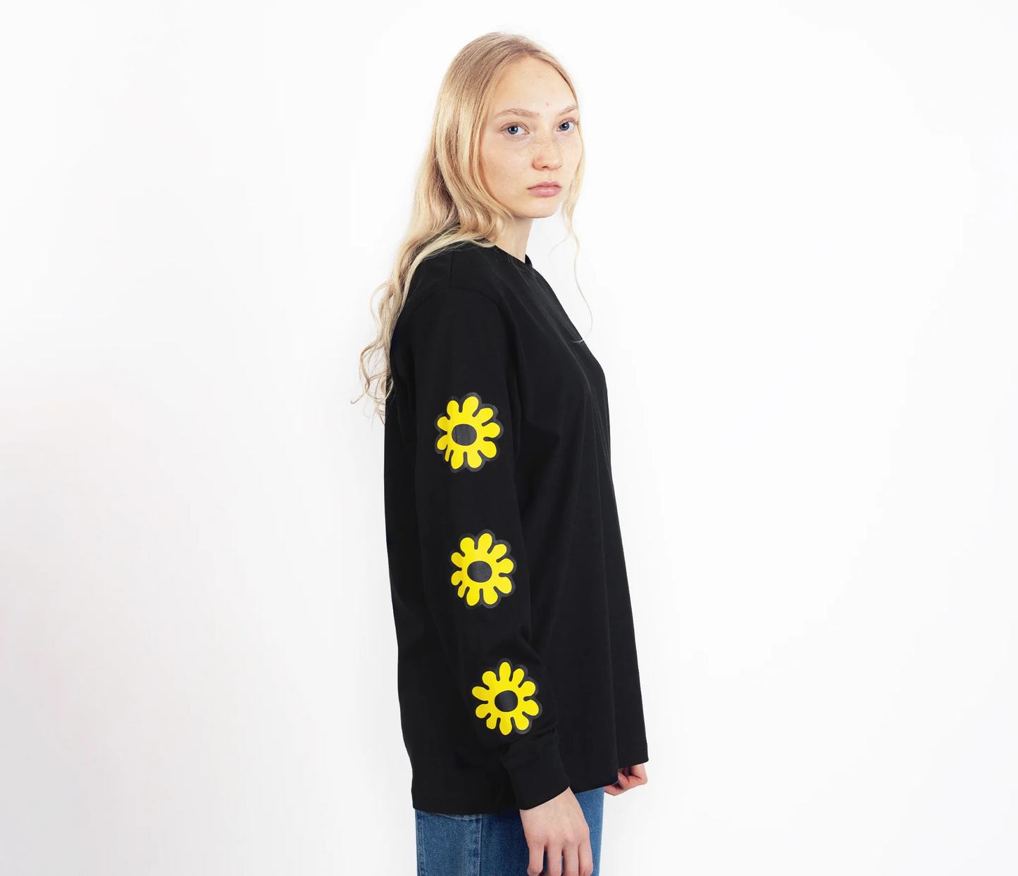 Moomintroll flower long sleeve shirt in black with vibrant yellow flower designs on sleeves